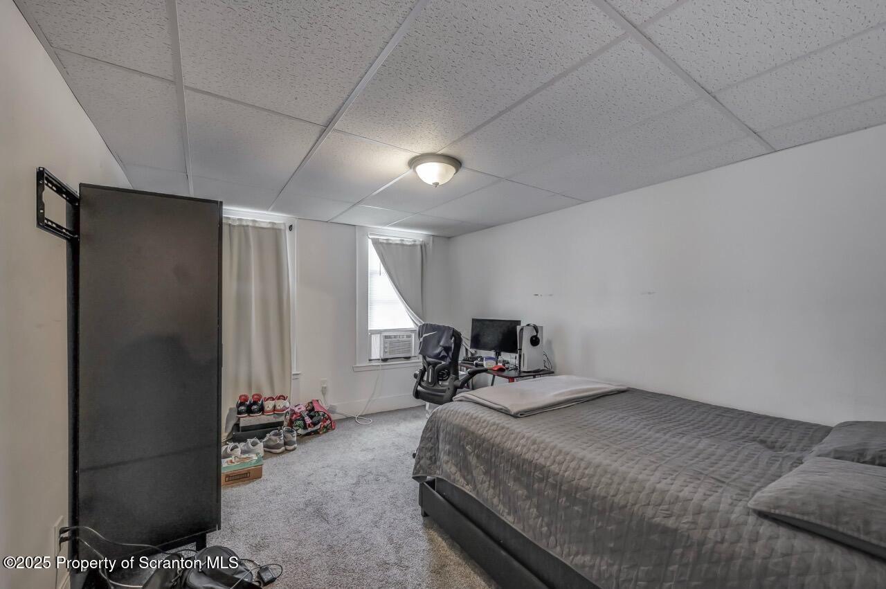 317-319 10th Avenue Scranton, PA 18504 - Photo 23 of 64 a bedroom with a bed and a table in it