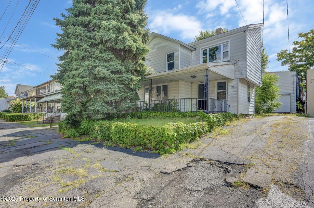 317-319 10th Avenue Scranton, PA 18504 - Photo 25 of 64 a front view of a house with a garden