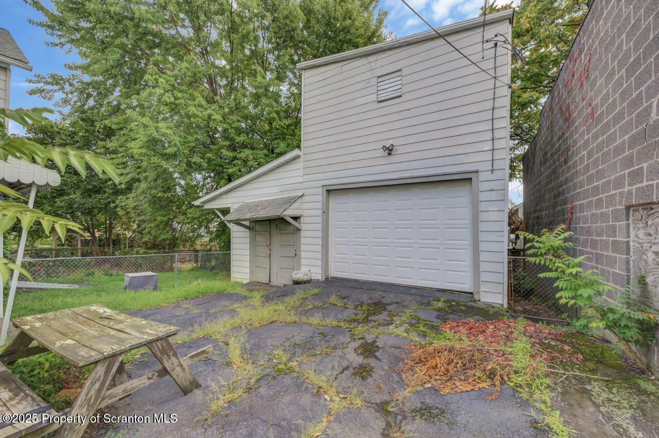 317-319 10th Avenue Scranton, PA 18504 - Photo 3 of 64 a backyard of a house with table and chairs