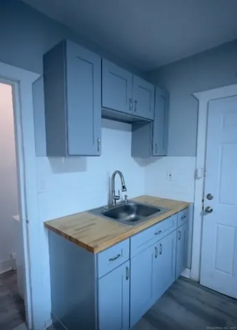 a kitchen with sink a cabinets and wooden floor