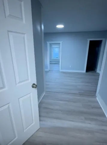 a view of hallway with wooden floor