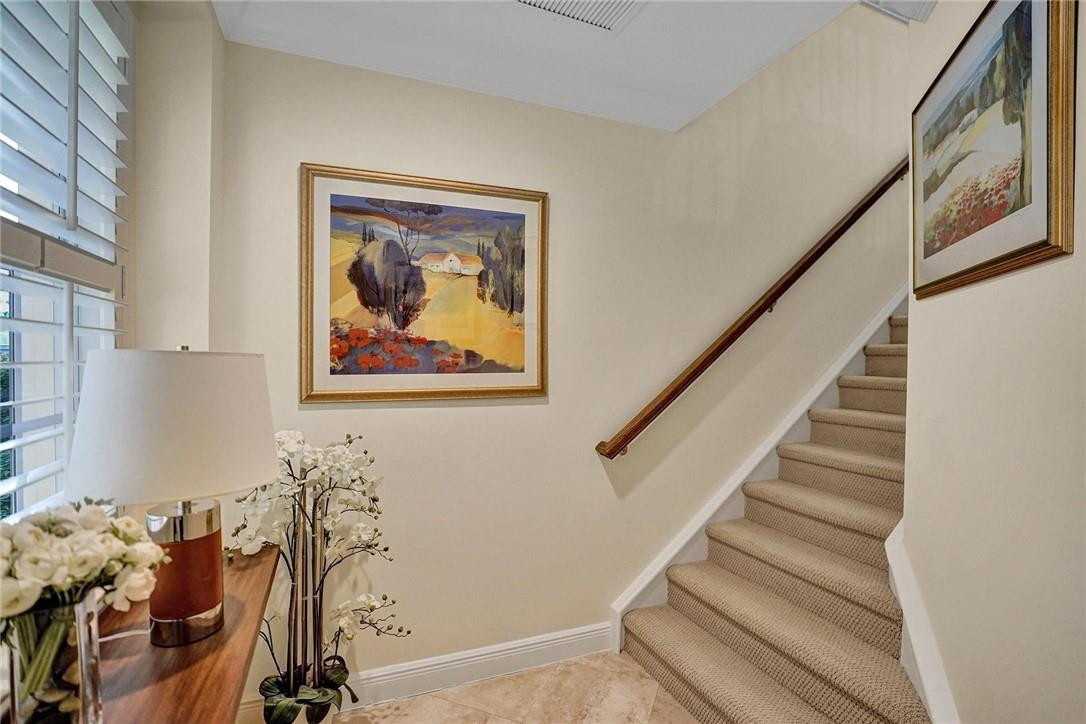 5565 Northeast Trieste Way, Unit 5565 Boca Raton, FL 33487 - Photo 11 of 44 a view of a hallway with stairs