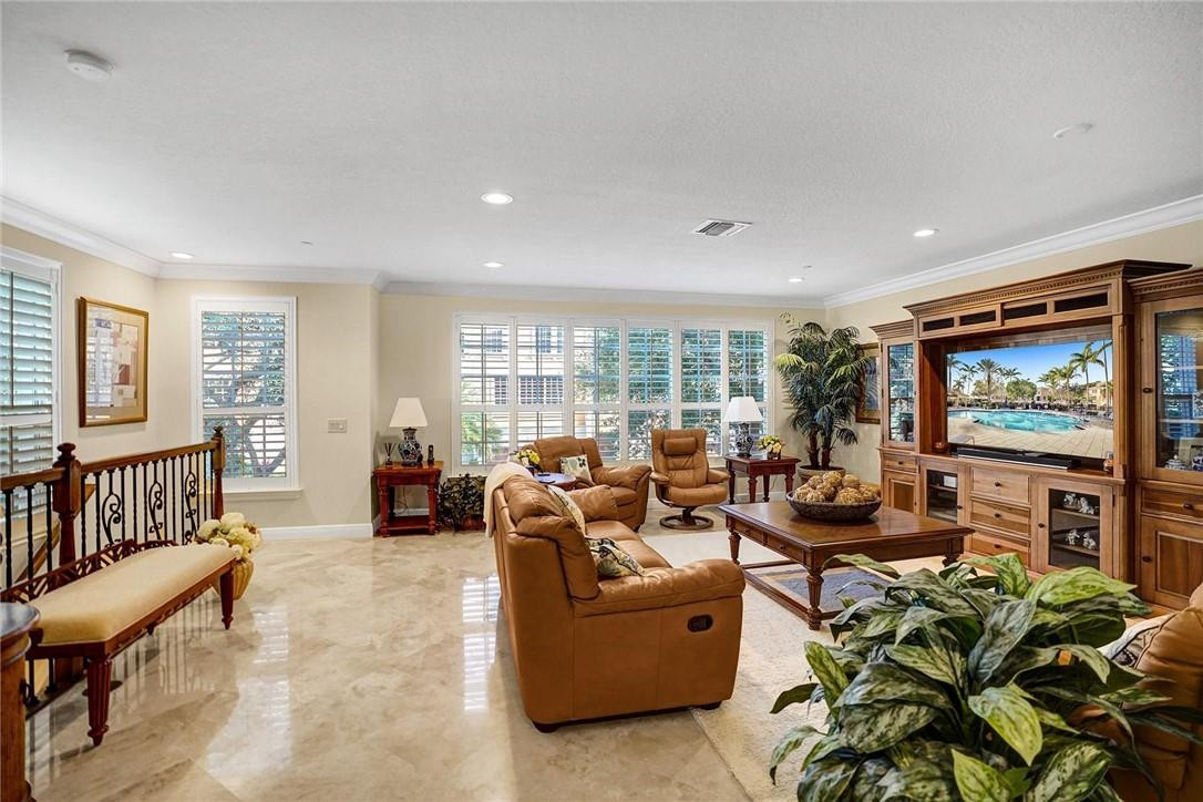 5565 Northeast Trieste Way, Unit 5565 Boca Raton, FL 33487 - Photo 12 of 44 a living room with fireplace furniture and a flat screen tv