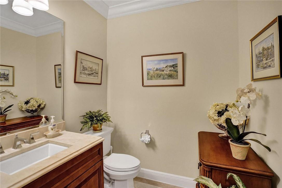 5565 Northeast Trieste Way, Unit 5565 Boca Raton, FL 33487 - Photo 13 of 44 a bathroom with a sink mirror and toilet
