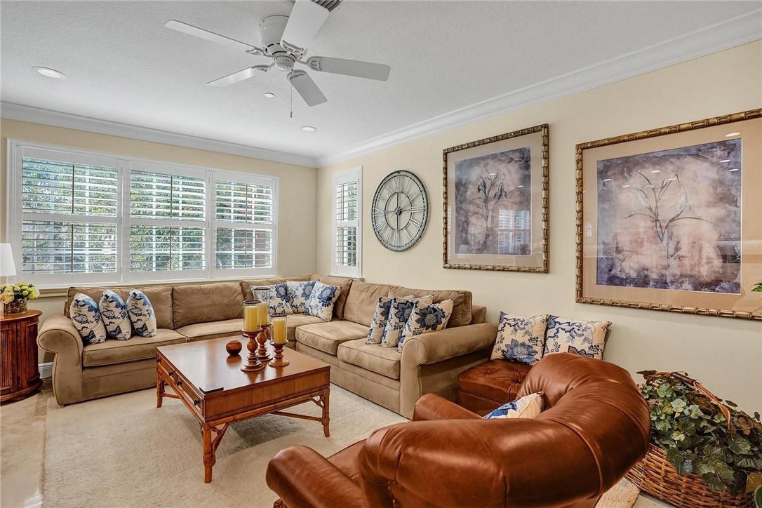 5565 Northeast Trieste Way, Unit 5565 Boca Raton, FL 33487 - Photo 15 of 44 a living room with furniture and a large window