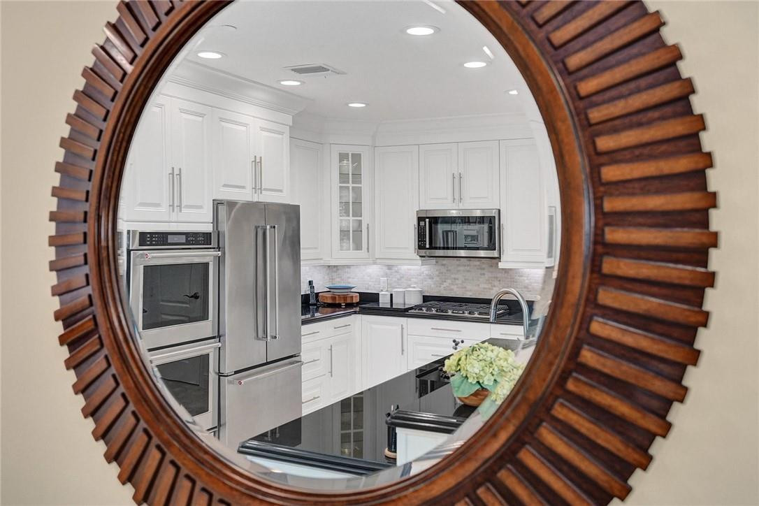 5565 Northeast Trieste Way, Unit 5565 Boca Raton, FL 33487 - Photo 18 of 44 a kitchen with stainless steel appliances granite countertop a stove top oven a sink and dishwasher