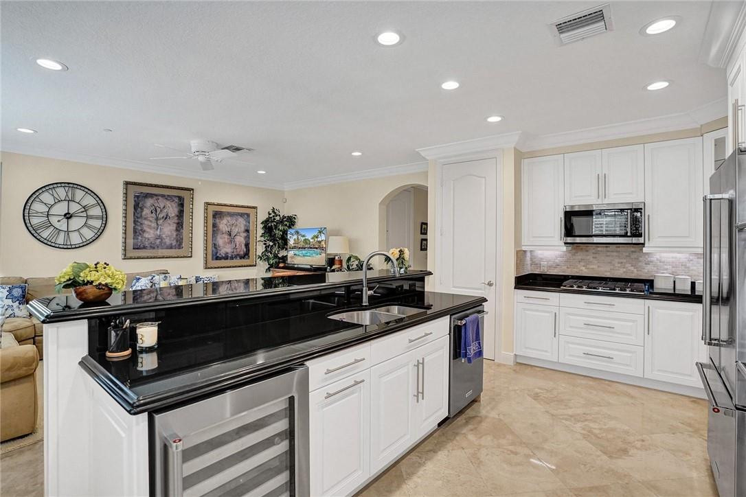 5565 Northeast Trieste Way, Unit 5565 Boca Raton, FL 33487 - Photo 19 of 44 a kitchen with stainless steel appliances a sink and cabinets