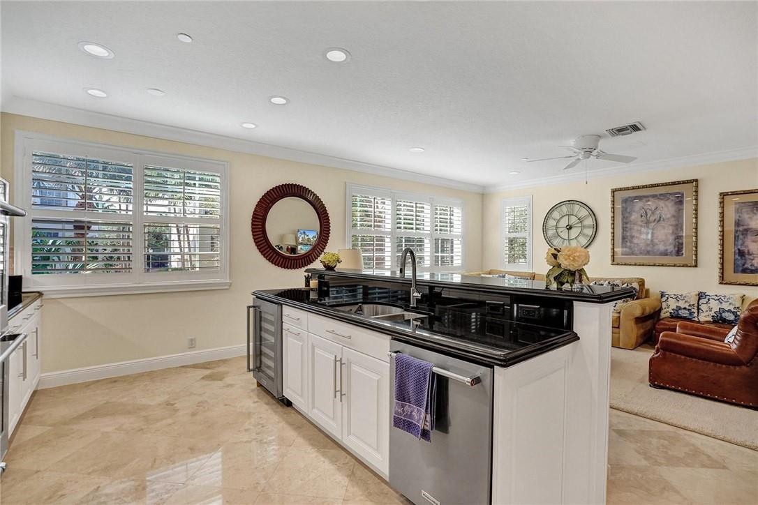 5565 Northeast Trieste Way, Unit 5565 Boca Raton, FL 33487 - Photo 21 of 44 a kitchen with stainless steel appliances granite countertop a stove and a sink