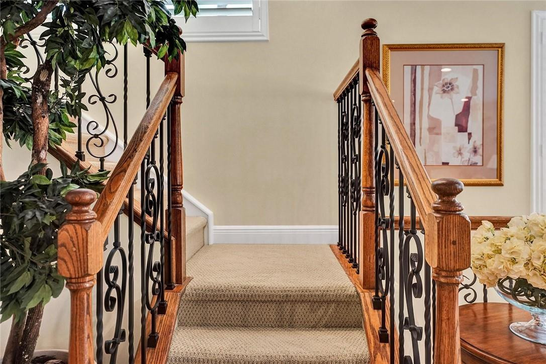 5565 Northeast Trieste Way, Unit 5565 Boca Raton, FL 33487 - Photo 22 of 44 a view of staircase with white walls and a painting on the wall