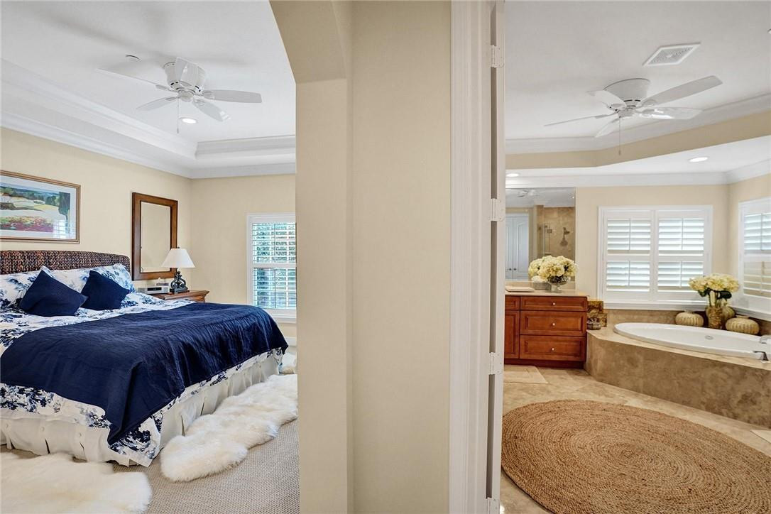 5565 Northeast Trieste Way, Unit 5565 Boca Raton, FL 33487 - Photo 24 of 44 a living room with a bed furniture and a dresser