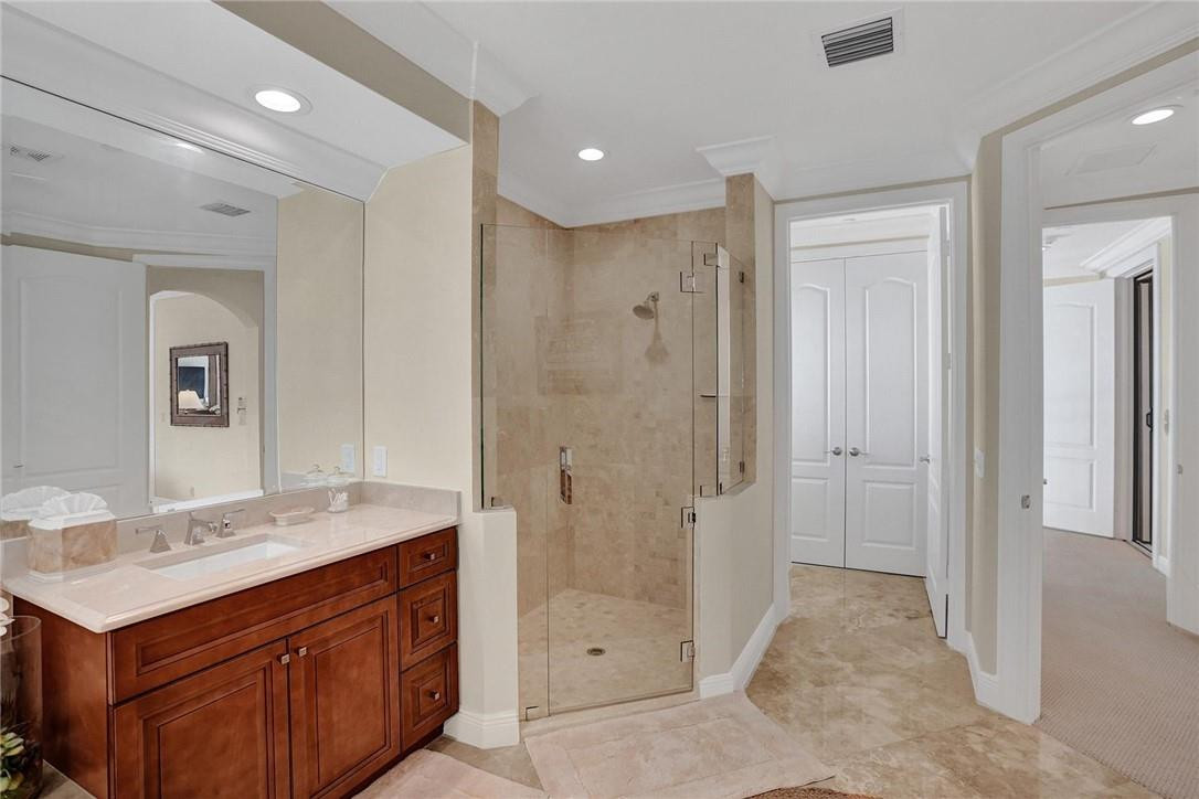 5565 Northeast Trieste Way, Unit 5565 Boca Raton, FL 33487 - Photo 26 of 44 a spacious bathroom with a shower sink and mirror