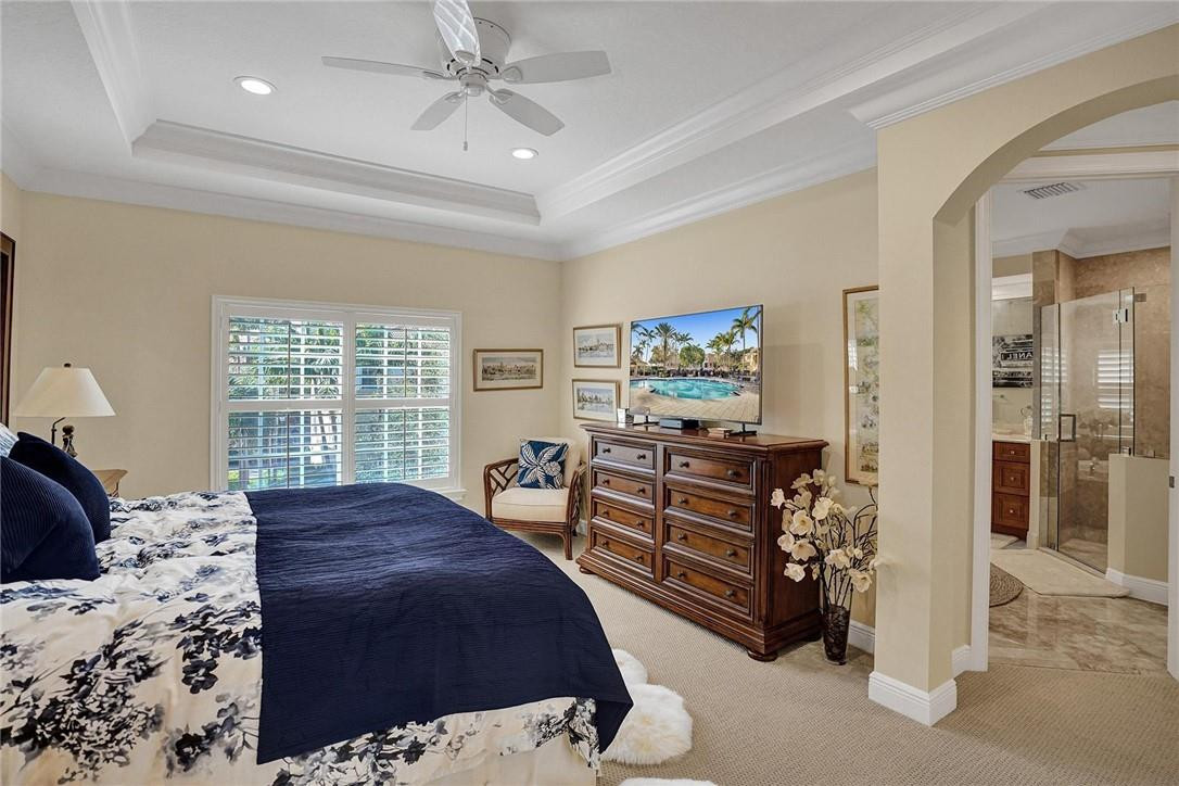 5565 Northeast Trieste Way, Unit 5565 Boca Raton, FL 33487 - Photo 28 of 44 a bed room with a bed and a window