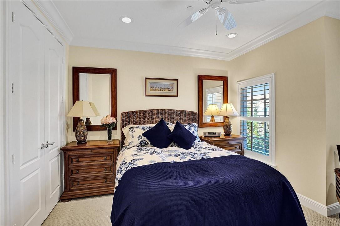 5565 Northeast Trieste Way, Unit 5565 Boca Raton, FL 33487 - Photo 29 of 44 a bedroom with a large bed and a window