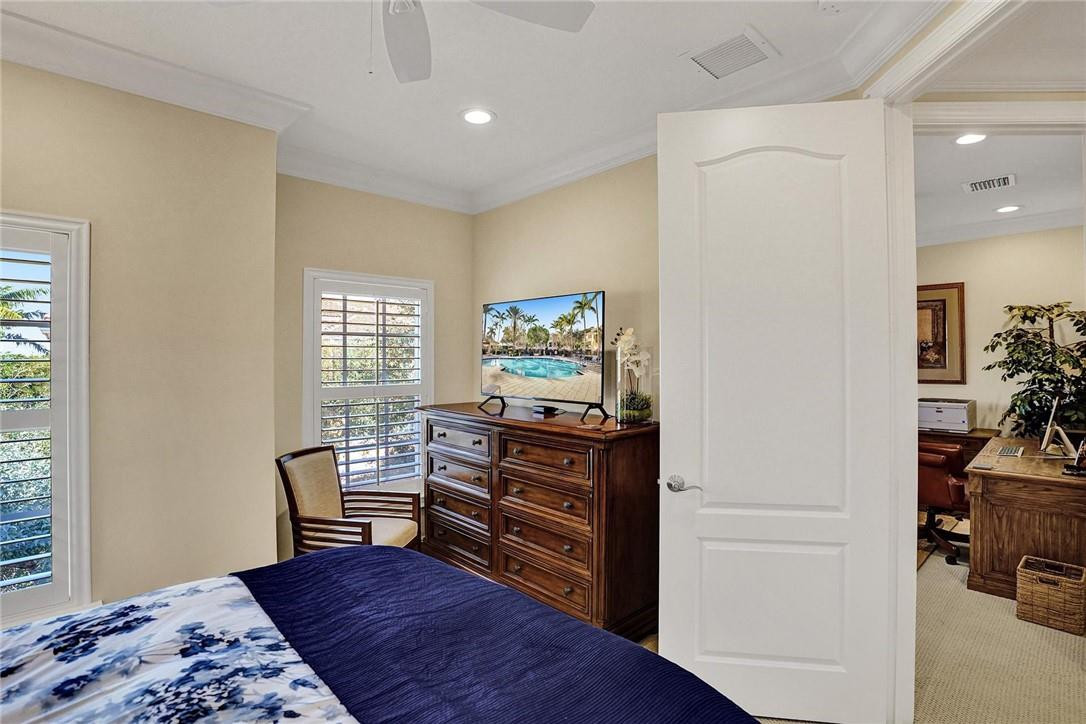 5565 Northeast Trieste Way, Unit 5565 Boca Raton, FL 33487 - Photo 30 of 44 a bedroom with furniture and a window