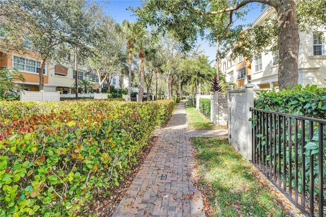 5565 Northeast Trieste Way, Unit 5565 Boca Raton, FL 33487 - Photo 36 of 44 a view of a yard with plants and large trees