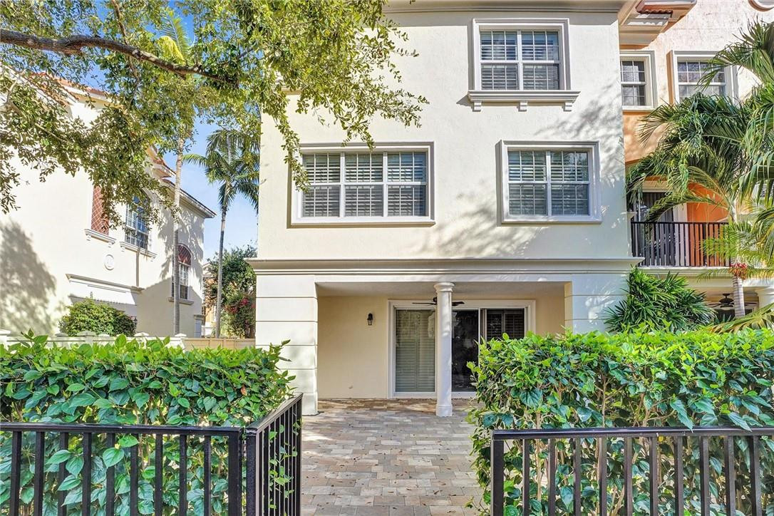 5565 Northeast Trieste Way, Unit 5565 Boca Raton, FL 33487 - Photo 37 of 44 front view of a house with a garden