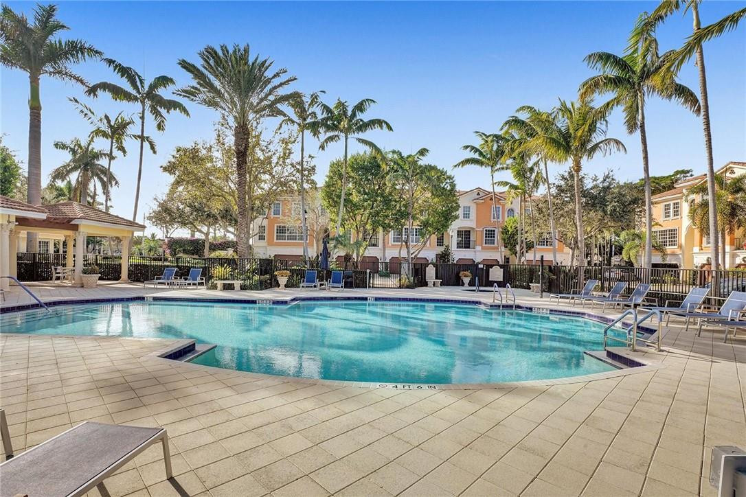 5565 Northeast Trieste Way, Unit 5565 Boca Raton, FL 33487 - Photo 39 of 44 a view of a swimming pool and a chair