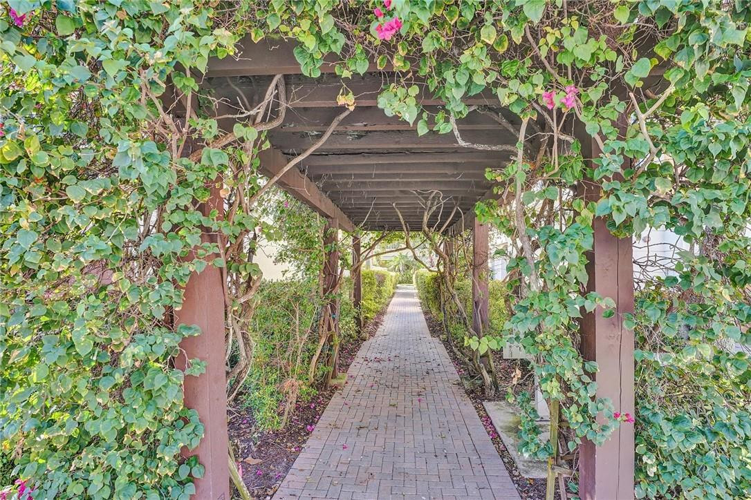 5565 Northeast Trieste Way, Unit 5565 Boca Raton, FL 33487 - Photo 42 of 44 a view of a backyard with potted plants