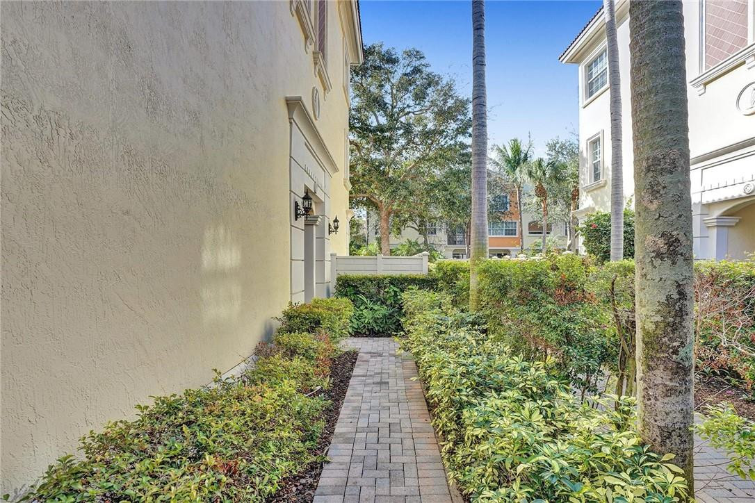 5565 Northeast Trieste Way, Unit 5565 Boca Raton, FL 33487 - Photo 43 of 44 a view of a pathway both side of the house