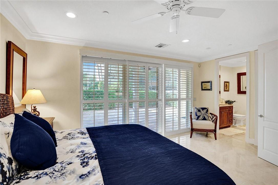5565 Northeast Trieste Way, Unit 5565 Boca Raton, FL 33487 - Photo 8 of 44 a bedroom with bed and window
