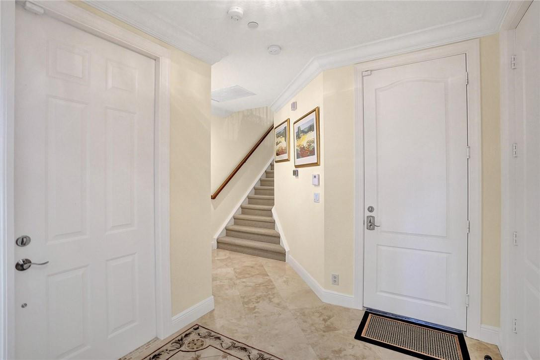 5565 Northeast Trieste Way, Unit 5565 Boca Raton, FL 33487 - Photo 10 of 44 a view of a hallway with staircase