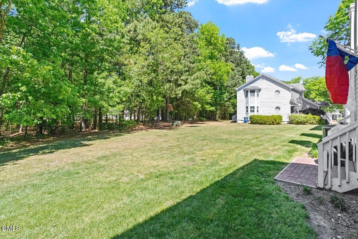 8321 Hempshire Place, Unit 103 Raleigh, NC 27613 - Photo 23 of 25 a front view of a house with garden