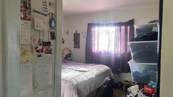 a bedroom with a bed and a window