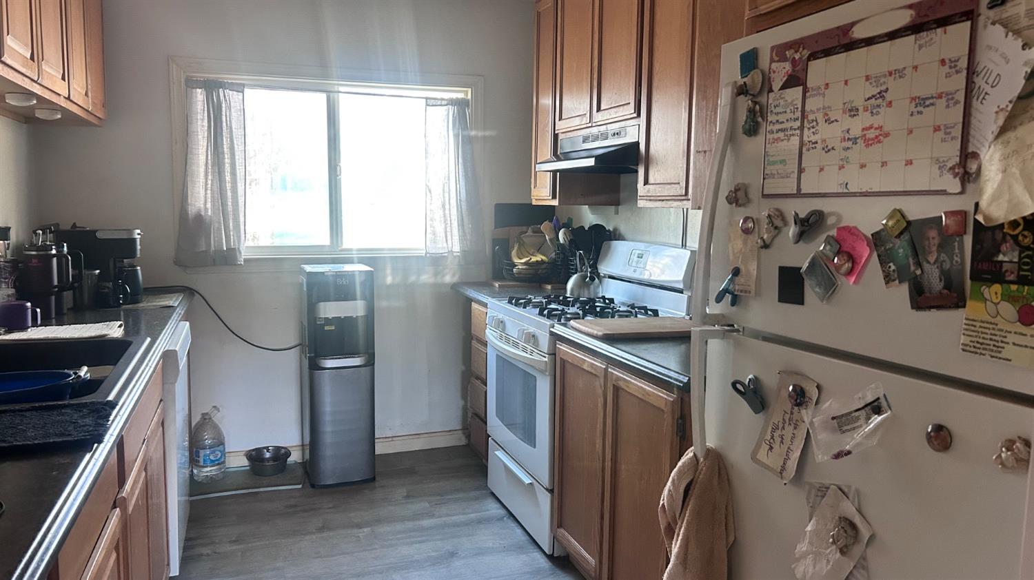 8186 Ave A Mountain Ranch, CA 95246 - Photo 6 of 8 a kitchen with stainless steel appliances a sink a stove and a refrigerator