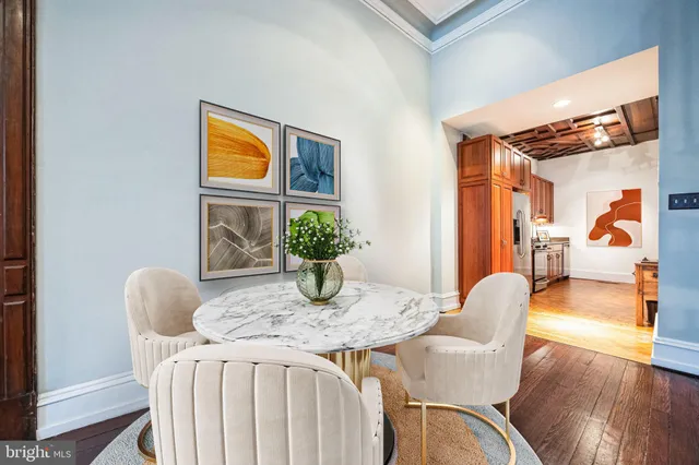 a dining room with furniture and wooden floor