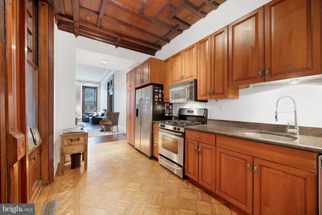 a kitchen with stainless steel appliances granite countertop a sink and cabinets