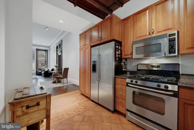 a kitchen with stainless steel appliances a stove a sink and a microwave