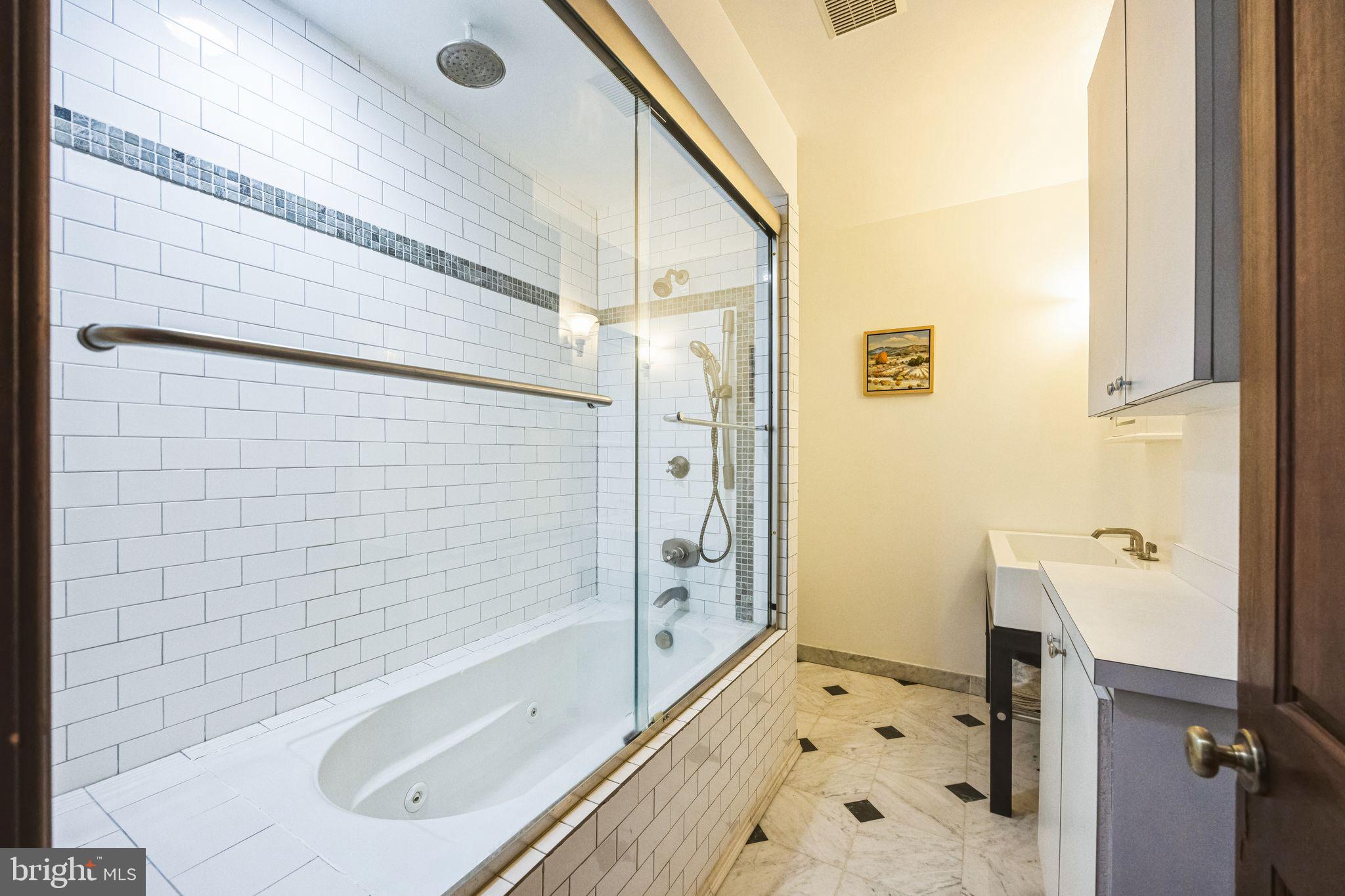 1717 Spring Garden Street, Unit A Philadelphia, PA 19130 - Photo 30 of 35 a bathroom with a bathtub and a shower