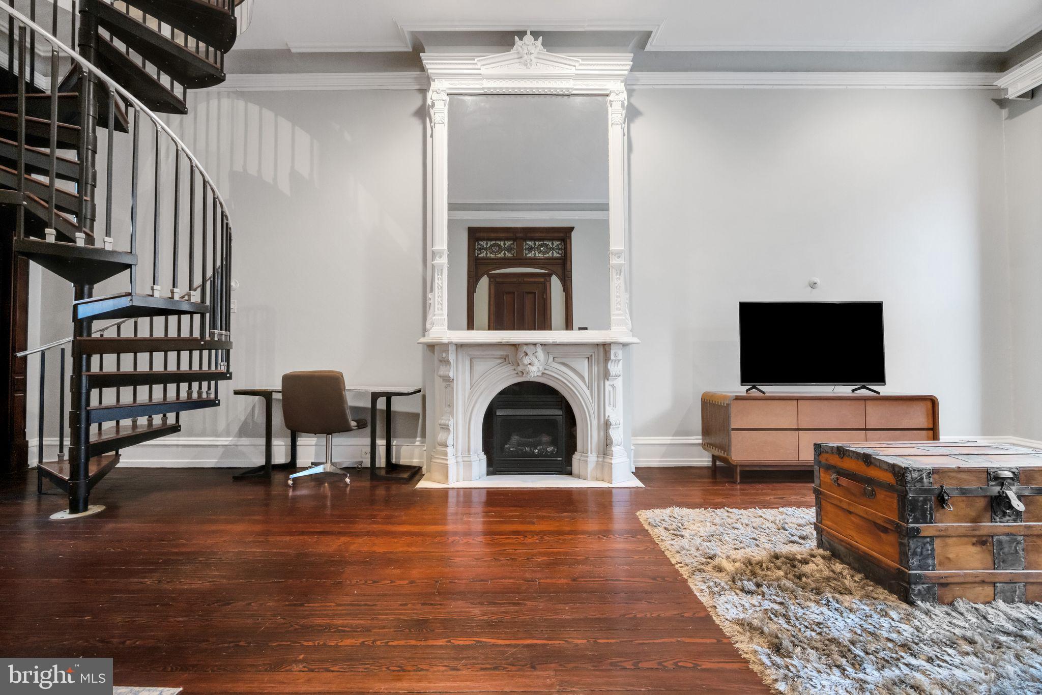 1717 Spring Garden Street, Unit A Philadelphia, PA 19130 - Photo 5 of 35 a living room with furniture and a fireplace