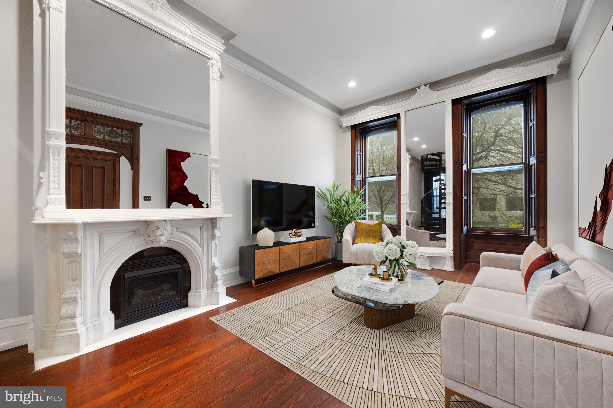 1717 Spring Garden Street, Unit A Philadelphia, PA 19130 - Photo 8 of 35 a living room with furniture a fireplace and a flat screen tv