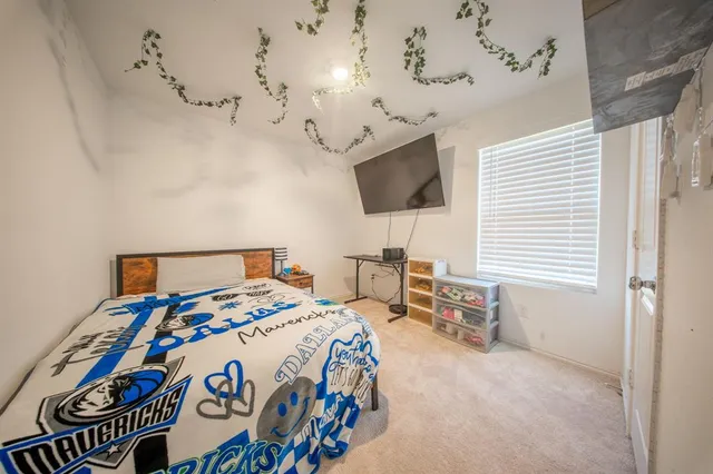 a bedroom with bed and a chandelier