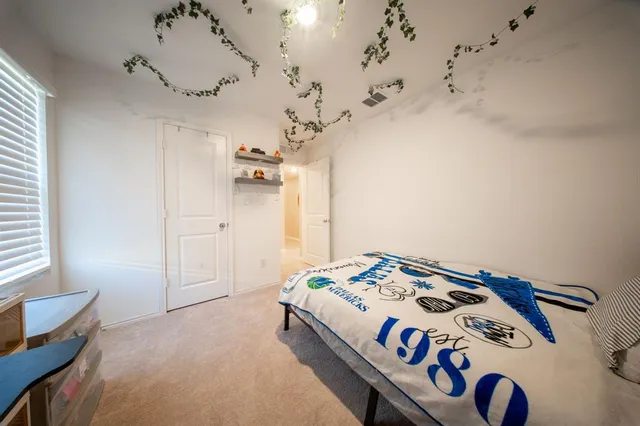 a bedroom with a bed and a table in it