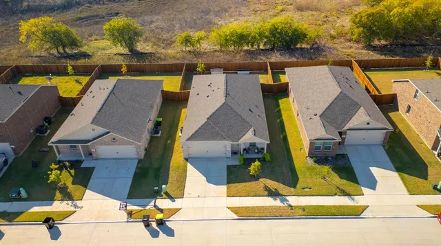 an aerial view of residential building with outdoor space and ocean view