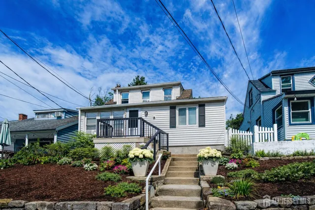 a front view of a house with plants and entryway