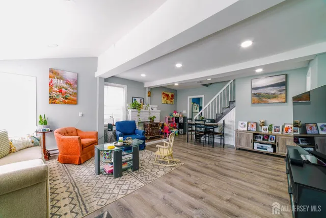 a living room with lots of furniture and wooden floor