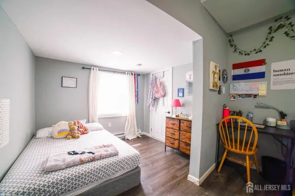 a bedroom with furniture and a wooden floor