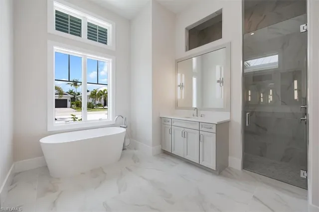 a bathroom with a bathtub sink and mirror
