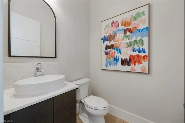 a bathroom with a toilet a sink and mirror