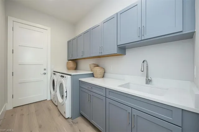 a kitchen with stainless steel appliances granite countertop a sink a stove and cabinets