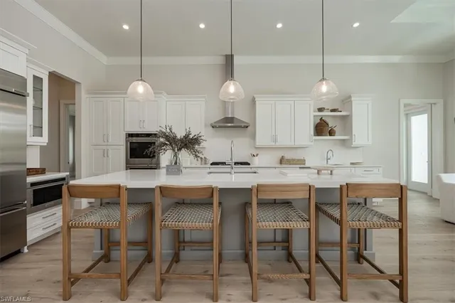 a kitchen with a dining table chairs sink and stove
