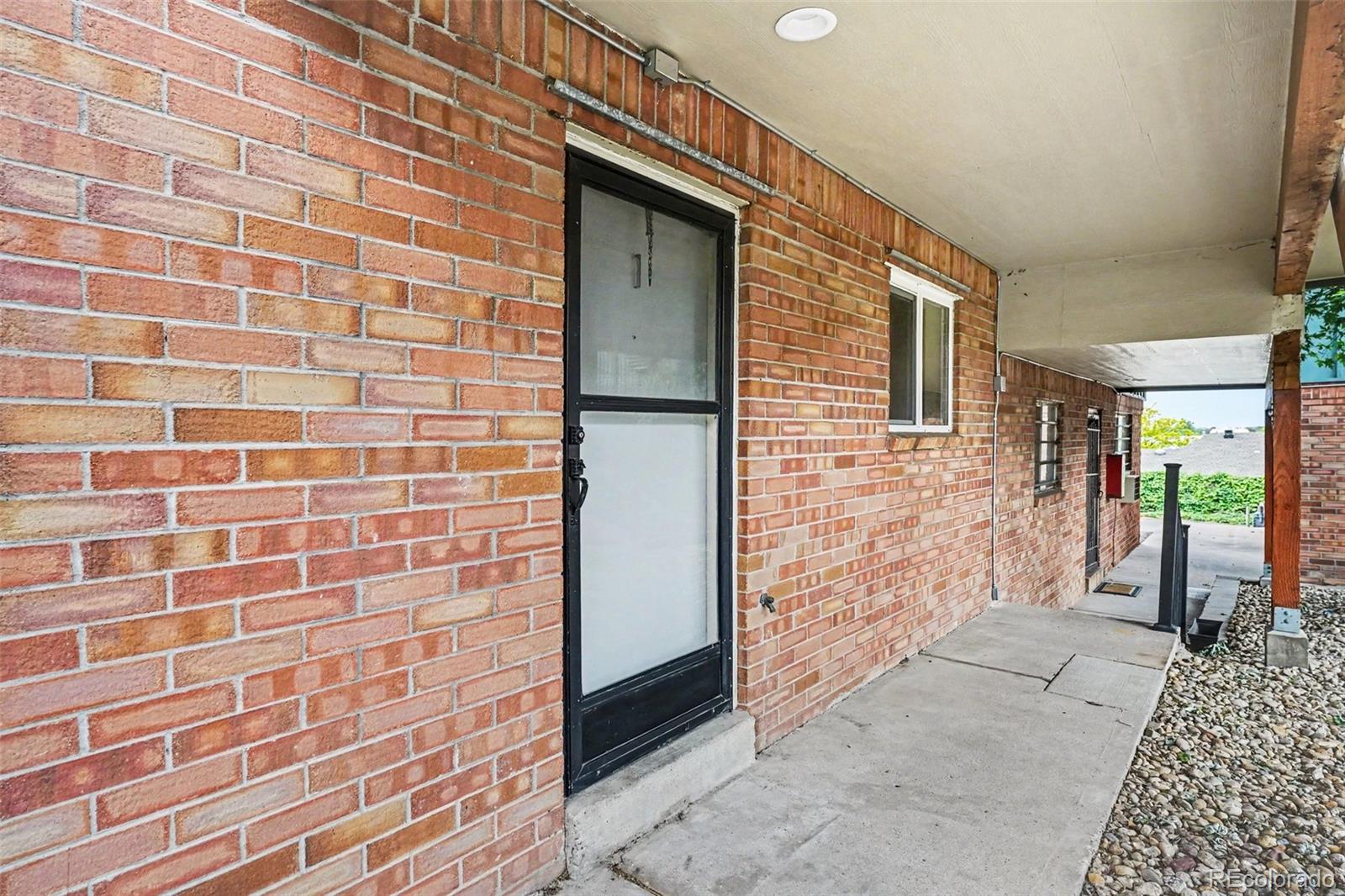 5700 West 28th Avenue, Unit 1 Wheat Ridge, CO 80214 - Photo 17 of 25 a view of a brick house with an outdoor space