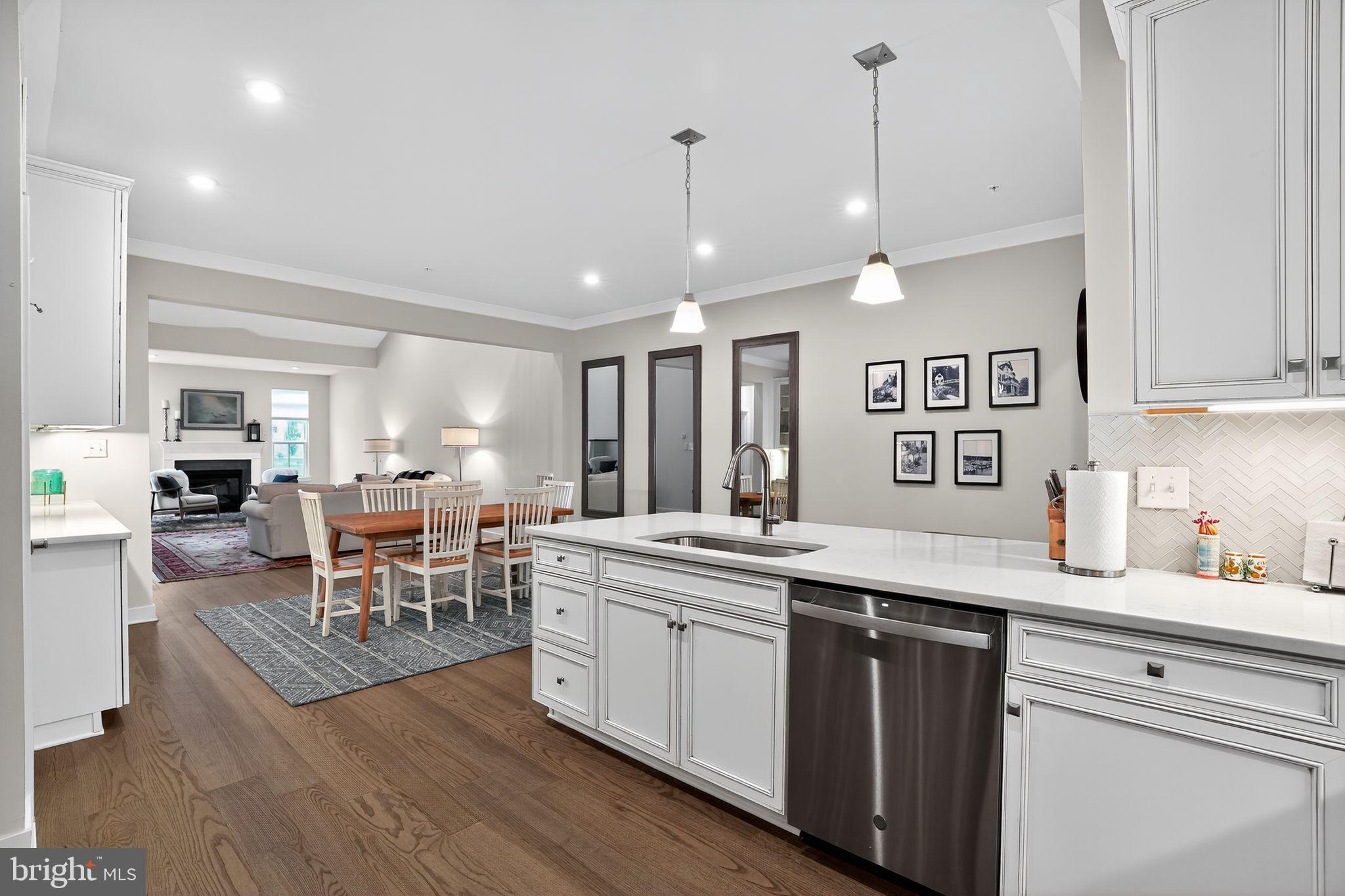 701 Cascade Way Kennett Square, PA 19348 - Photo 11 of 46 a open kitchen with stainless steel appliances granite countertop a sink dishwasher a stove and a dining table with wooden floor