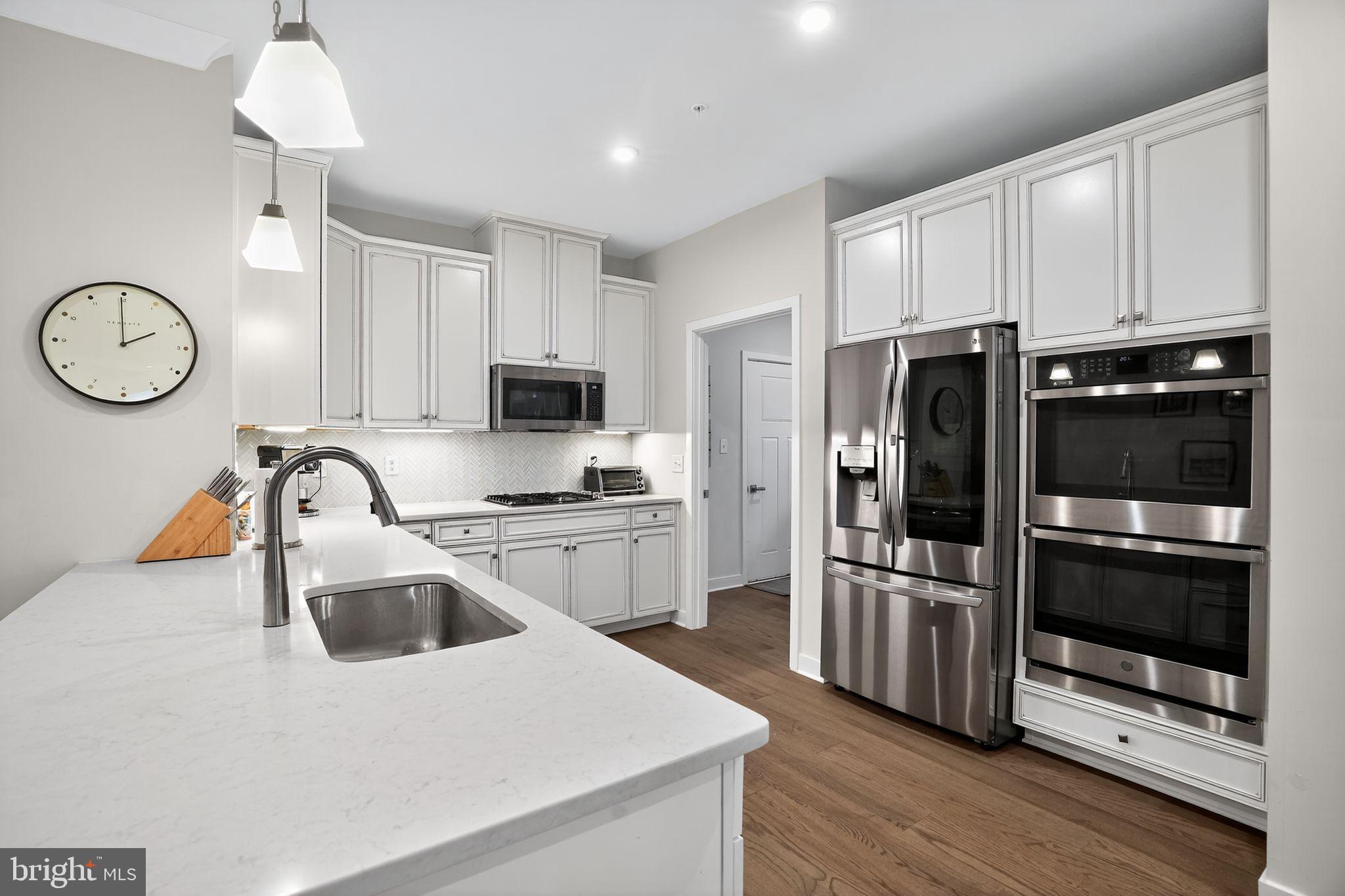 701 Cascade Way Kennett Square, PA 19348 - Photo 13 of 46 a kitchen with a refrigerator a sink and a stove