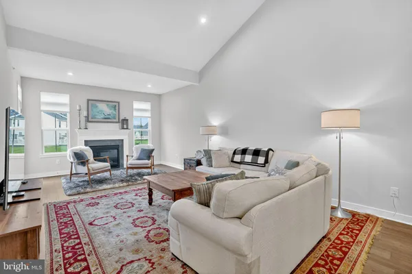 a living room with furniture a fireplace and a table