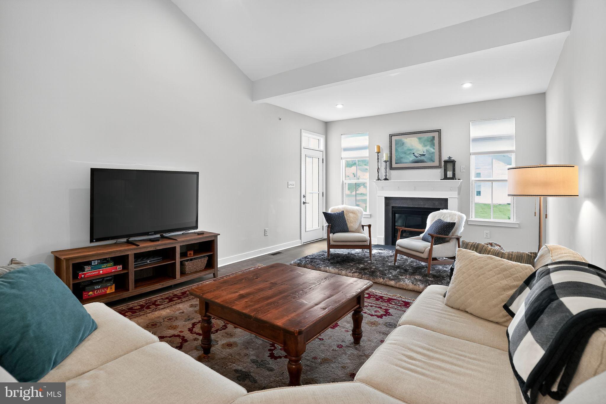 701 Cascade Way Kennett Square, PA 19348 - Photo 18 of 46 a living room with furniture a flat screen tv and a fireplace
