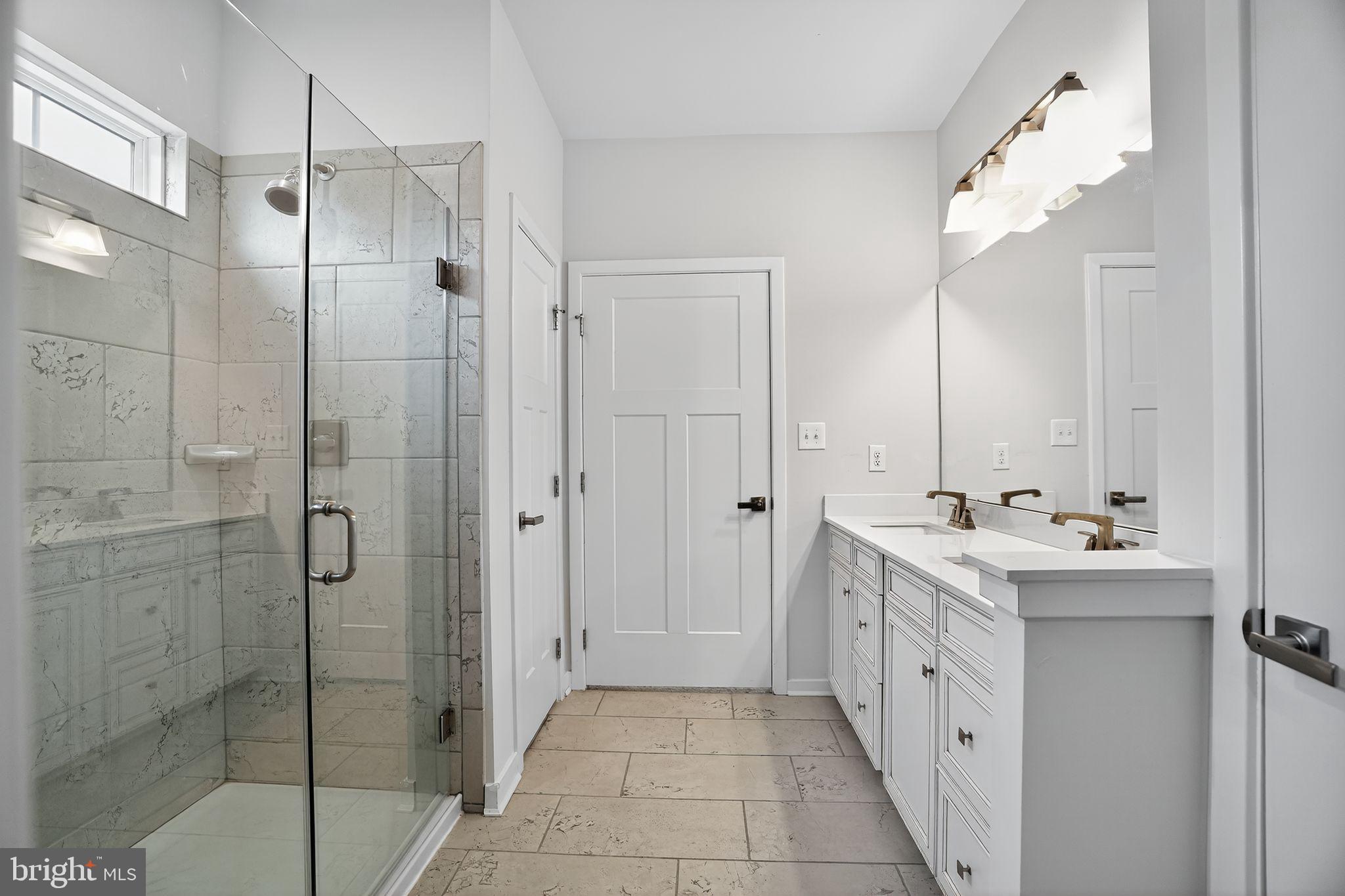 701 Cascade Way Kennett Square, PA 19348 - Photo 26 of 46 a bathroom with a double vanity sink mirror and shower